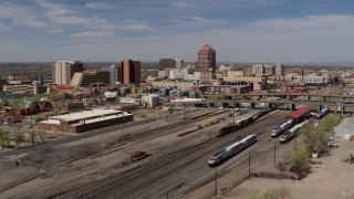 DX0002_124_035 - 5.7K aerial stock footage fly over train tracks toward office buildings in the background, Downtown Albuquerque, New Mexico
