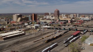 DX0002_124_038 - 5.7K aerial stock footage approach train tracks and office buildings in the distance, Downtown Albuquerque, New Mexico