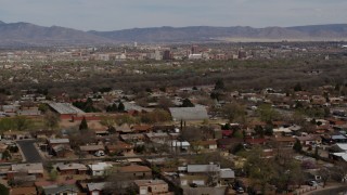 DX0002_126_007 - 5.7K stock footage aerial video flyby a suburban neighborhood with Downtown Albuquerque in the distance, New Mexico