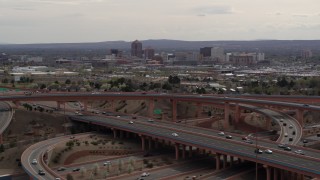 DX0002_126_020 - 5.7K aerial stock footage of Downtown Albuquerque seen from a freeway interchange, New Mexico
