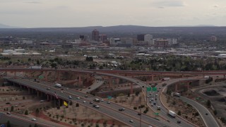 DX0002_126_025 - 5.7K aerial stock footage of Downtown Albuquerque seen from freeway interchange traffic, New Mexico