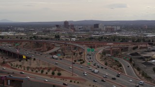 DX0002_126_027 - 5.7K aerial stock footage of Downtown Albuquerque buildings seen from freeway interchange traffic, New Mexico