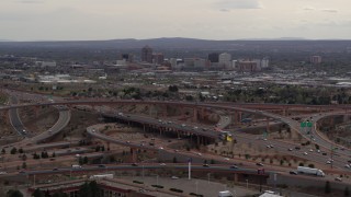 DX0002_126_029 - 5.7K aerial stock footage of Downtown Albuquerque buildings seen while flying by freeway interchange traffic, New Mexico