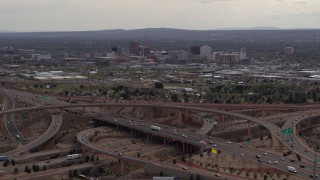 DX0002_126_030 - 5.7K aerial stock footage of Downtown Albuquerque buildings seen while passing freeway interchange traffic, New Mexico