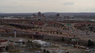 DX0002_126_032 - 5.7K aerial stock footage of Downtown Albuquerque buildings seen from a freeway interchange, New Mexico