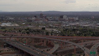 DX0002_126_033 - 5.7K aerial stock footage approach freeway interchange, ascend for view of Downtown Albuquerque, New Mexico