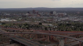 DX0002_126_034 - 5.7K aerial stock footage of Downtown Albuquerque high-rises seen from freeway interchange, New Mexico