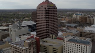 DX0002_127_005 - 5.7K aerial stock footage flying away from Albuquerque Plaza and neighboring city buildings, Downtown Albuquerque, New Mexico