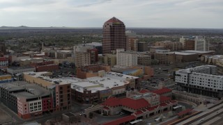 DX0002_127_006 - 5.7K aerial stock footage flying away from Albuquerque Plaza high-rise and neighboring city buildings, Downtown Albuquerque, New Mexico