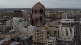 DX0002_127_010 - 5.7K aerial stock footage fly toward Albuquerque Plaza and neighboring city buildings, Downtown Albuquerque, New Mexico