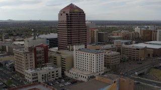 DX0002_127_011 - 5.7K aerial stock footage orbit and fly away from Albuquerque Plaza and neighboring city buildings, Downtown Albuquerque, New Mexico