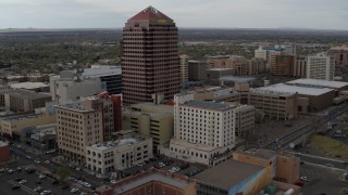 DX0002_127_012 - 5.7K aerial stock footage fly toward Albuquerque Plaza and other city buildings, Downtown Albuquerque, New Mexico