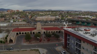 DX0002_127_022 - 5.7K aerial stock footage reverse view of the entrance of the Albuquerque train station, Downtown Albuquerque, New Mexico