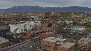 DX0002_127_025 - 5.7K aerial stock footage of flying by office and apartment buildings, Downtown Albuquerque, New Mexico