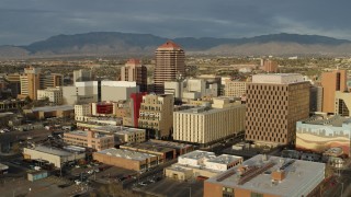 DX0002_127_029 - 5.7K aerial stock footage approach and flyby Albuquerque Plaza towering over city buildings, Downtown Albuquerque, New Mexico