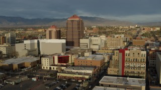 DX0002_127_035 - 5.7K aerial stock footage descend and orbit office high-rise and city buildings, Downtown Albuquerque, New Mexico