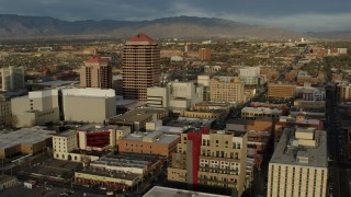 DX0002_127_037 - 5.7K aerial stock footage of approaching office high-rise and city buildings, Downtown Albuquerque, New Mexico