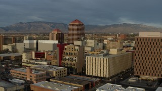 DX0002_127_041 - 5.7K aerial stock footage orbit office high-rise at the center of city buildings, Downtown Albuquerque, New Mexico