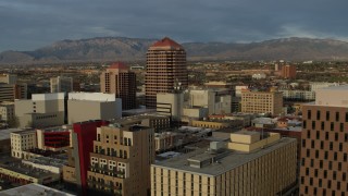 DX0002_127_043 - 5.7K aerial stock footage fly away from office high-rise, reveal federal building, Downtown Albuquerque, New Mexico