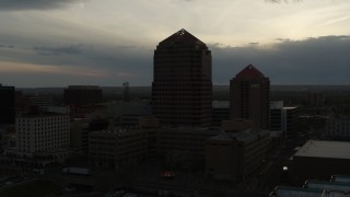 DX0002_128_001 - 5.7K aerial stock footage orbit office high-rise and hotel at sunset, Downtown Albuquerque, New Mexico