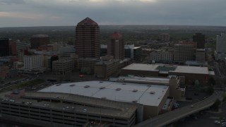 DX0002_128_004 - 5.7K aerial stock footage orbit office high-rise and hotel by convention center at sunset, Downtown Albuquerque, New Mexico