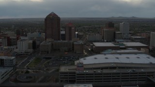 DX0002_128_005 - 5.7K aerial stock footage orbit around office high-rise, hotel, convention center, Kiva Auditorium at sunset, Downtown Albuquerque, New Mexico