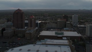 DX0002_128_006 - 5.7K aerial stock footage orbit office high-rise, hotel, and the Kiva Auditorium at sunset, Downtown Albuquerque, New Mexico