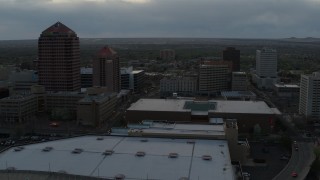 DX0002_128_007 - 5.7K aerial stock footage orbit office high-rise, hotel, Kiva Auditorium at sunset, Downtown Albuquerque, New Mexico