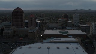 DX0002_128_008 - 5.7K aerial stock footage orbiting the office high-rise, hotel, Kiva Auditorium at sunset, Downtown Albuquerque, New Mexico