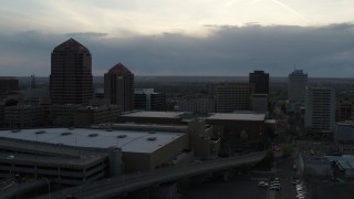 DX0002_128_011 - 5.7K aerial stock footage flyby office tower, hotel, Kiva Auditorium, convention center at sunset, Downtown Albuquerque, New Mexico