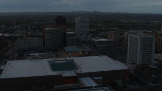 DX0002_128_013 - 5.7K aerial stock footage flyby hotel, office buildings, Kiva Auditorium at sunset, Downtown Albuquerque, New Mexico