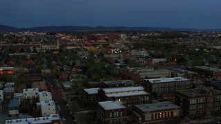 DX0002_128_014 - 5.7K aerial stock footage of a hospital seen from downtown at twilight, Albuquerque, New Mexico