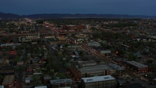 DX0002_128_015 - 5.7K aerial stock footage of a view of a hospital from downtown at twilight, Albuquerque, New Mexico