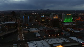 DX0002_128_019 - 5.7K aerial stock footage approach office buildings near hotel at twilight, Downtown Albuquerque, New Mexico
