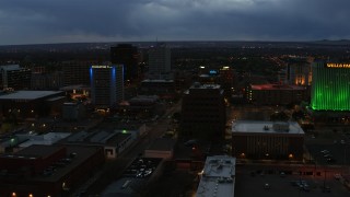 DX0002_128_020 - 5.7K aerial stock footage orbit office buildings near hotel at twilight, Downtown Albuquerque, New Mexico