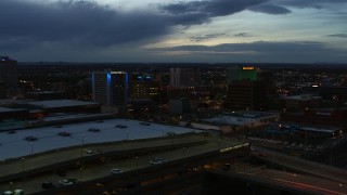 DX0002_128_022 - 5.7K aerial stock footage fly over convention center to approach hotel and office buildings at twilight, Downtown Albuquerque, New Mexico