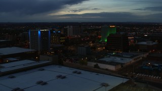 DX0002_128_023 - 5.7K aerial stock footage reverse view of hotel and office buildings at twilight, Downtown Albuquerque, New Mexico