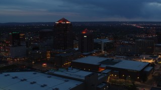 DX0002_128_027 - 5.7K stock footage aerial video ascend with view of office high-rise, hotel and Kiva Auditorium at twilight, Downtown Albuquerque, New Mexico