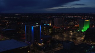 DX0002_128_039 - 5.7K aerial stock footage fly away from office buildings, reveal hotel at twilight, Downtown Albuquerque, New Mexico