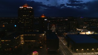 DX0002_128_041 - 5.7K aerial stock footage flyby city street, high-rise office building and hotel at twilight, Downtown Albuquerque, New Mexico