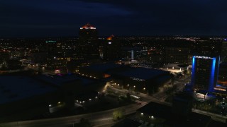 DX0002_128_045 - 5.7K aerial stock footage wide orbit of office high-rise, hotel and auditorium at twilight, Downtown Albuquerque, New Mexico