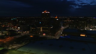 DX0002_128_046 - 5.7K aerial stock footage of office high-rise, hotel and auditorium at twilight, Downtown Albuquerque, New Mexico