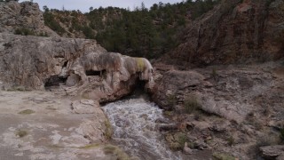 DX0002_129_003 - 5.7K aerial stock footage of an orbit of river rapids flowing through a rock formation in the mountains in New Mexico