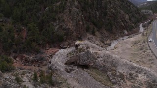DX0002_129_005 - 5.7K aerial stock footage ascend and fly away from river rapids flowing through a rock formation in the mountains in New Mexico