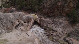 DX0002_129_007 - 5.7K aerial stock footage approach and orbit river rapids flowing through a rock formation in the mountains in New Mexico
