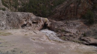 DX0002_129_008 - 5.7K aerial stock footage descend for low view of river rapids flowing through a rock formation in the mountains in New Mexico