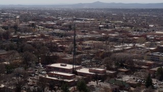DX0002_129_032 - 5.7K aerial stock footage passing Radio Plaza in the city's downtown area, Santa Fe, New Mexico