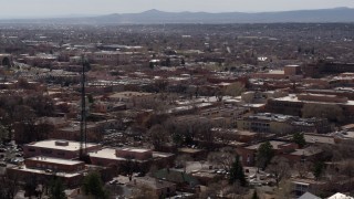 DX0002_129_033 - 5.7K aerial stock footage flyby Radio Plaza, ascend for view of the city's downtown area, Santa Fe, New Mexico