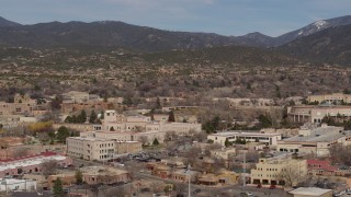 DX0002_129_038 - 5.7K aerial stock footage of flying by Bataan Memorial Building in the city's downtown area, Santa Fe, New Mexico