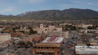 DX0002_130_010 - 5.7K aerial stock footage orbit Bataan Memorial Building, state capitol in background, Santa Fe, New Mexico